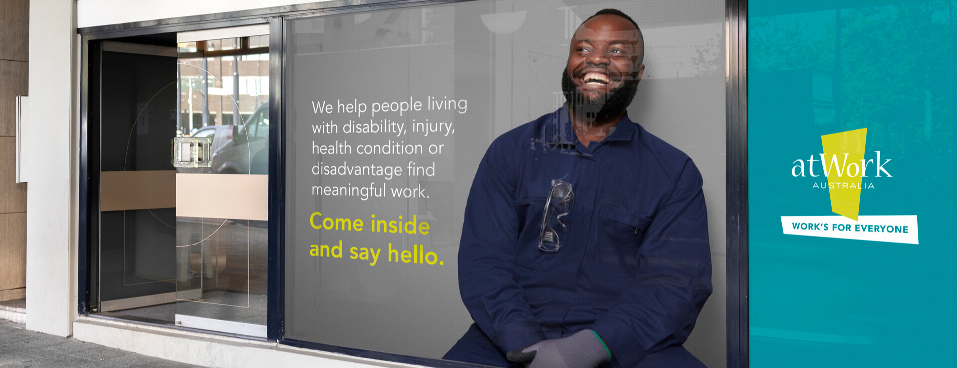 atWork Australia bus station advertisement featuring smiling man, designed by MOO Marketing & Design graphic design agency in Melbourne