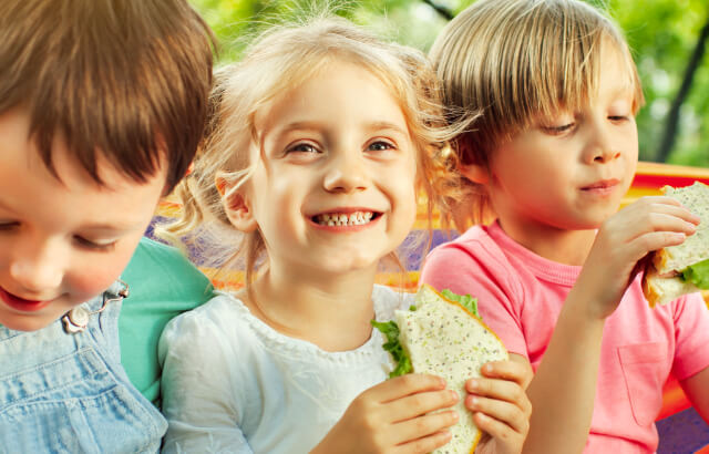 Grainbow ad featuring 3 children eating bread, designed by MOO Marketing marketing agency in Melbourne