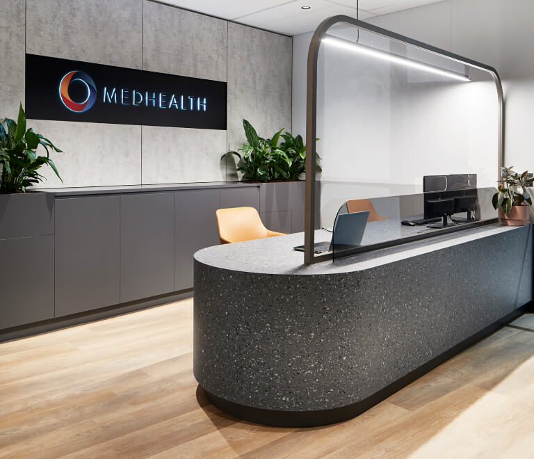Modern office reception area with Medhealth corporate logo on the wall, designed by MOO Marketing  Design marketing agency in Melbourne