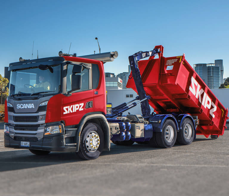Red skip loader truck with Skipz logo deisgned by MOO Marketing & Design graphid design & website design agency in Melbourne