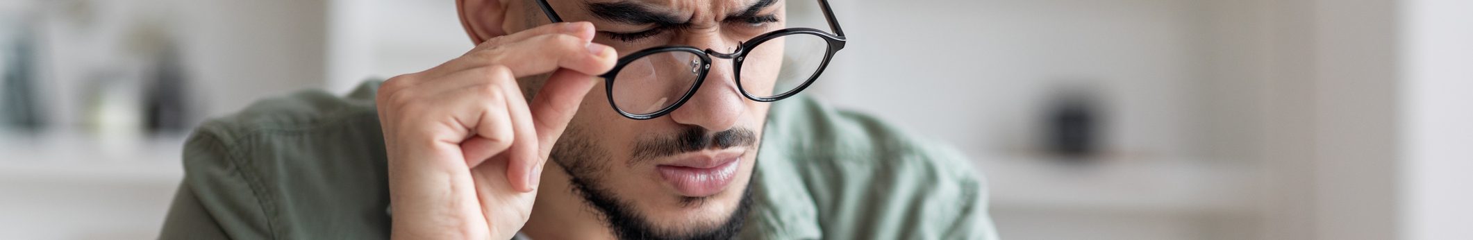 Man with glasses struggles to read, accessible grpahic design