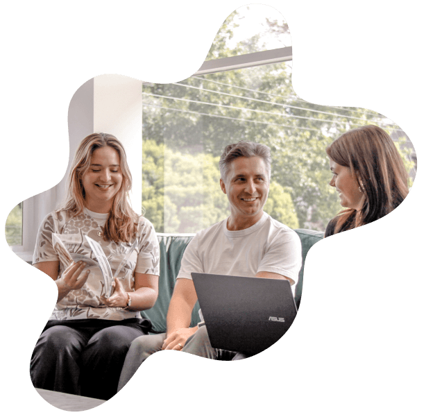 MOO graphic design team gathered around table discussing marketing agency services